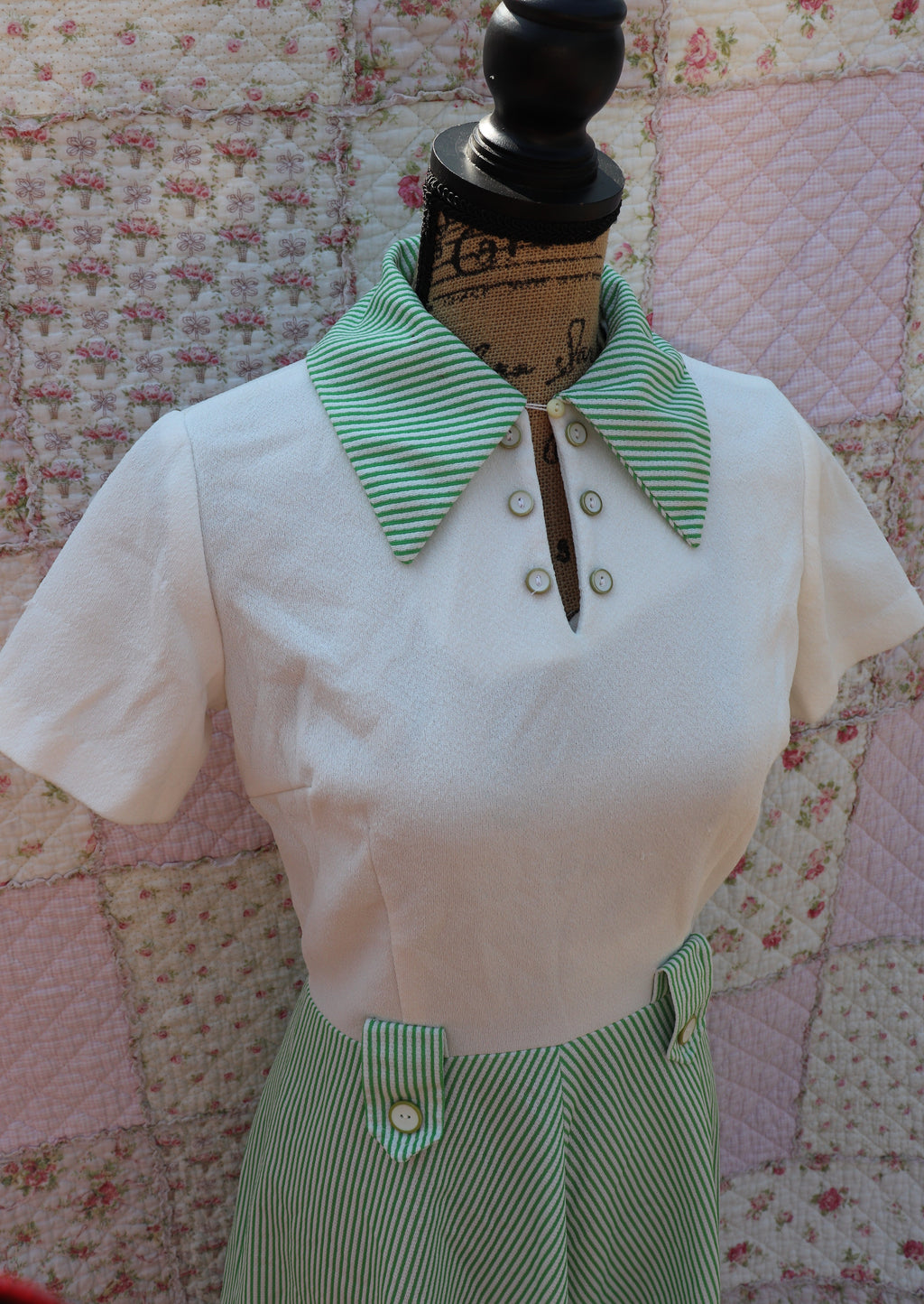 Introducing the Mabel Dress: a playful 1970s throwback. This white terry cloth dress features a green pinstripe skirt and collar, with a small cutout and cream buttons on the neck for added cuteness. Perfect for hitting the courts this summer!