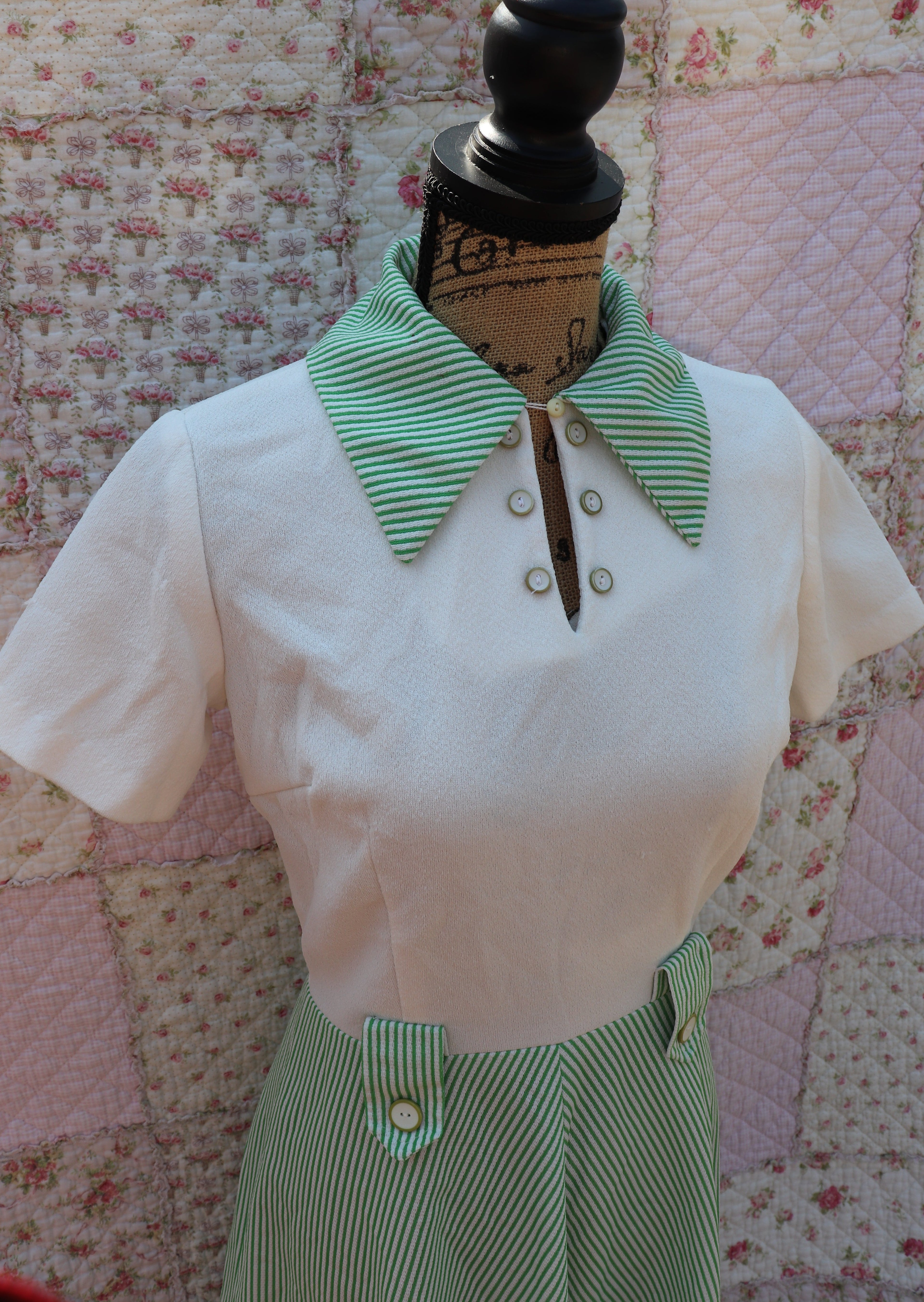 Introducing the Mabel Dress: a playful 1970s throwback. This white terry cloth dress features a green pinstripe skirt and collar, with a small cutout and cream buttons on the neck for added cuteness. Perfect for hitting the courts this summer!