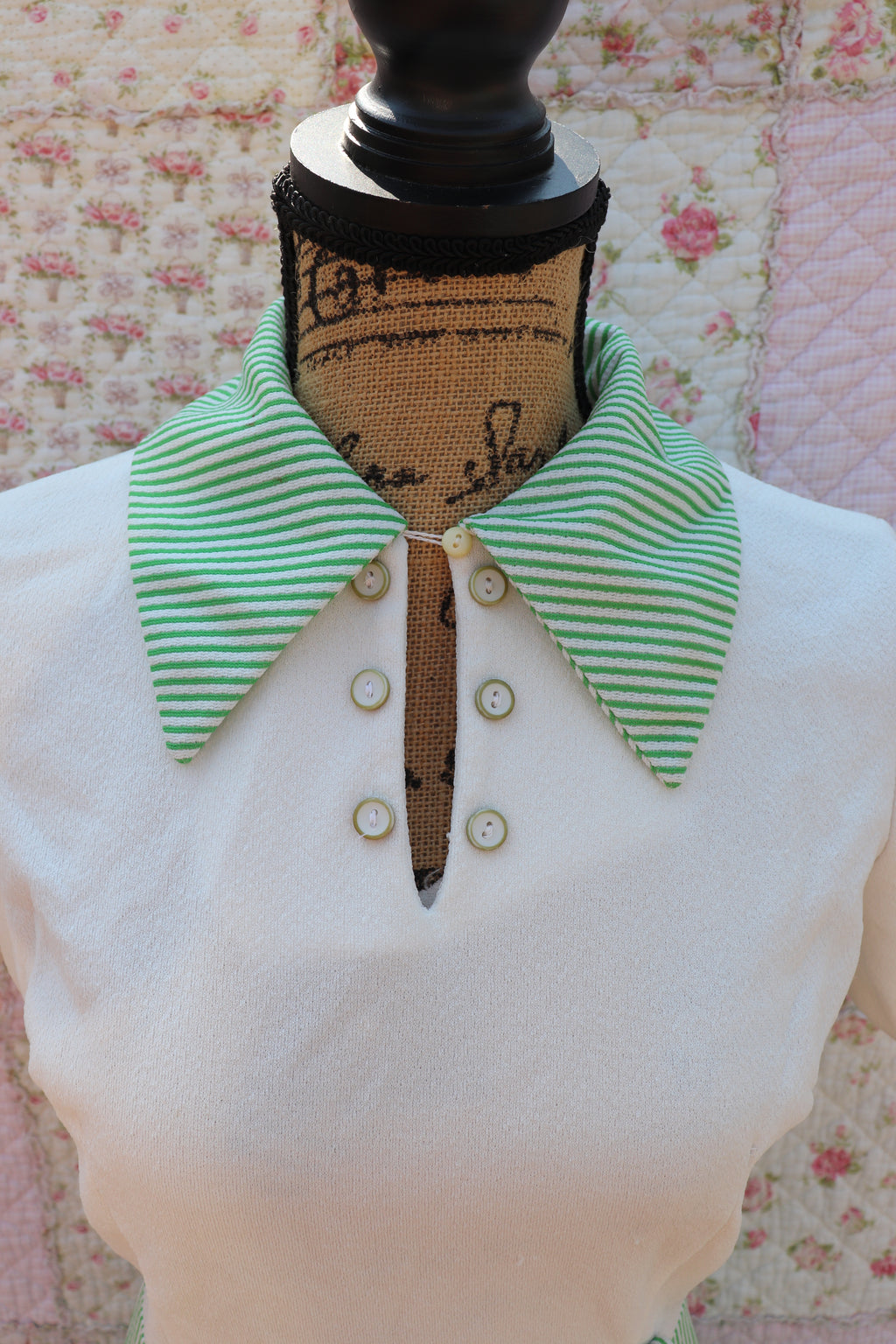 Introducing the Mabel Dress: a playful 1970s throwback. This white terry cloth dress features a green pinstripe skirt and collar, with a small cutout and cream buttons on the neck for added cuteness. Perfect for hitting the courts this summer!