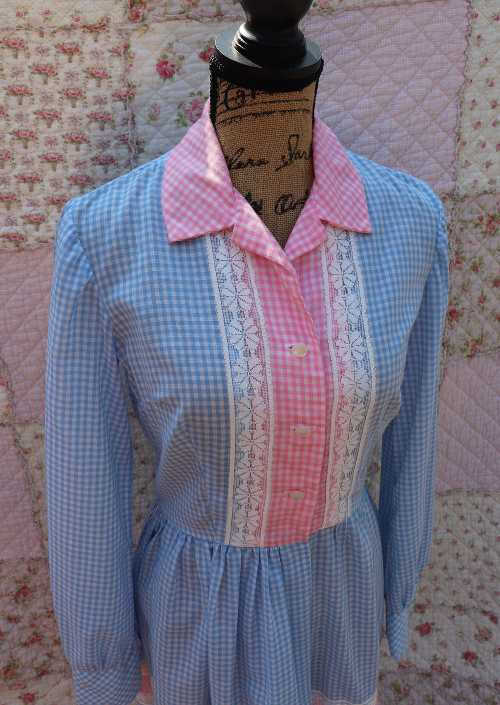 Soak up the sun in the iris dress from J&J Classics! This 1960s dress features a playful blue and white gingham print, accented with pink and white gingham. The long sleeves and collar add a touch of sophistication, while delicate floral lace details add a hint of sweet charm. Get ready to turn heads and spread some flower power with this dress!