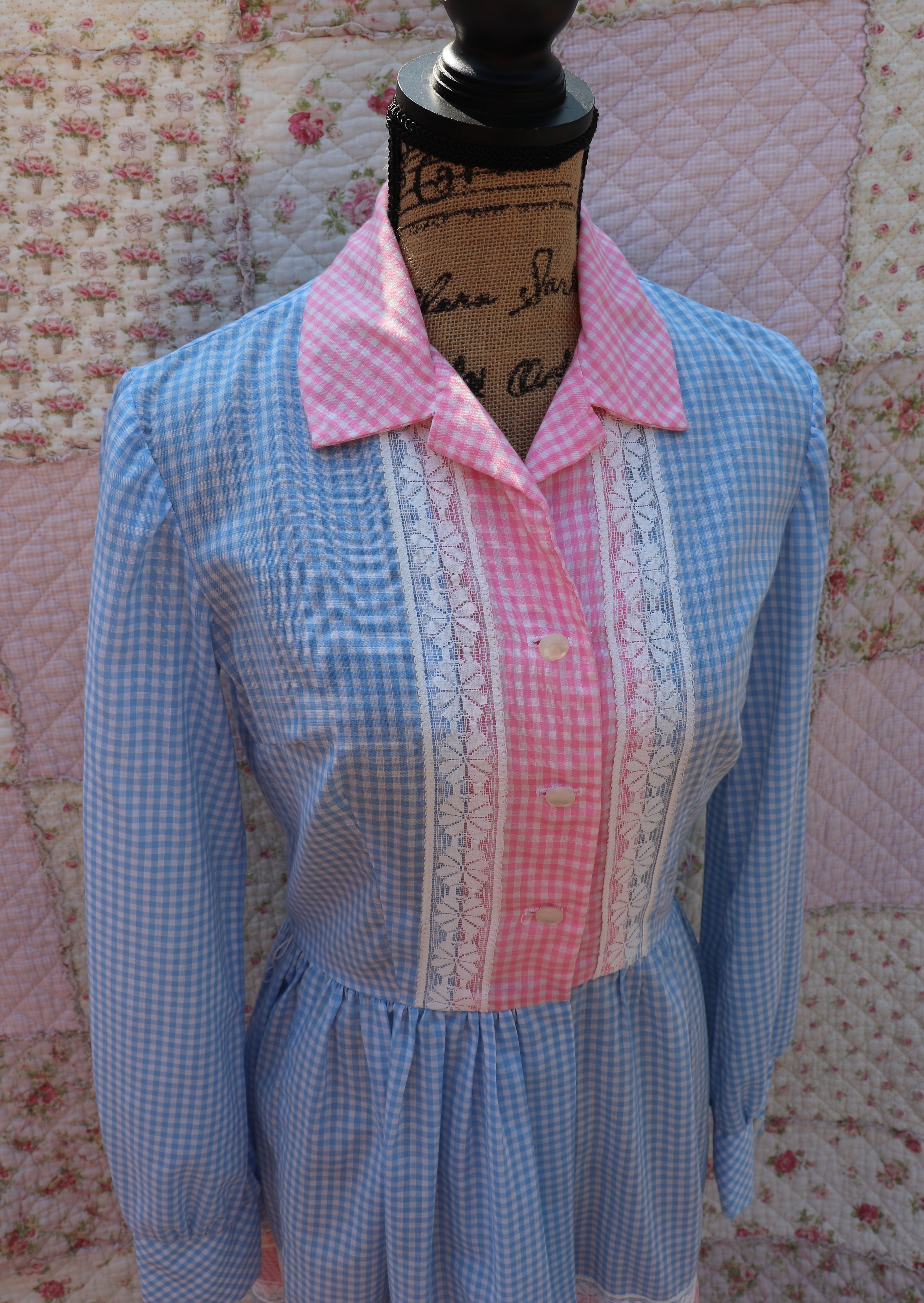 Soak up the sun in the iris dress from J&J Classics! This 1960s dress features a playful blue and white gingham print, accented with pink and white gingham. The long sleeves and collar add a touch of sophistication, while delicate floral lace details add a hint of sweet charm. Get ready to turn heads and spread some flower power with this dress!