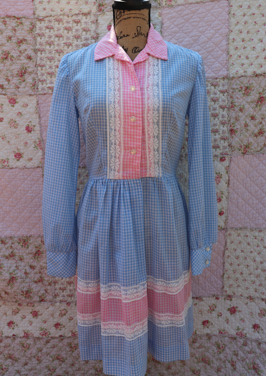 Soak up the sun in the iris dress from J&J Classics! This 1960s dress features a playful blue and white gingham print, accented with pink and white gingham. The long sleeves and collar add a touch of sophistication, while delicate floral lace details add a hint of sweet charm. Get ready to turn heads and spread some flower power with this dress!
