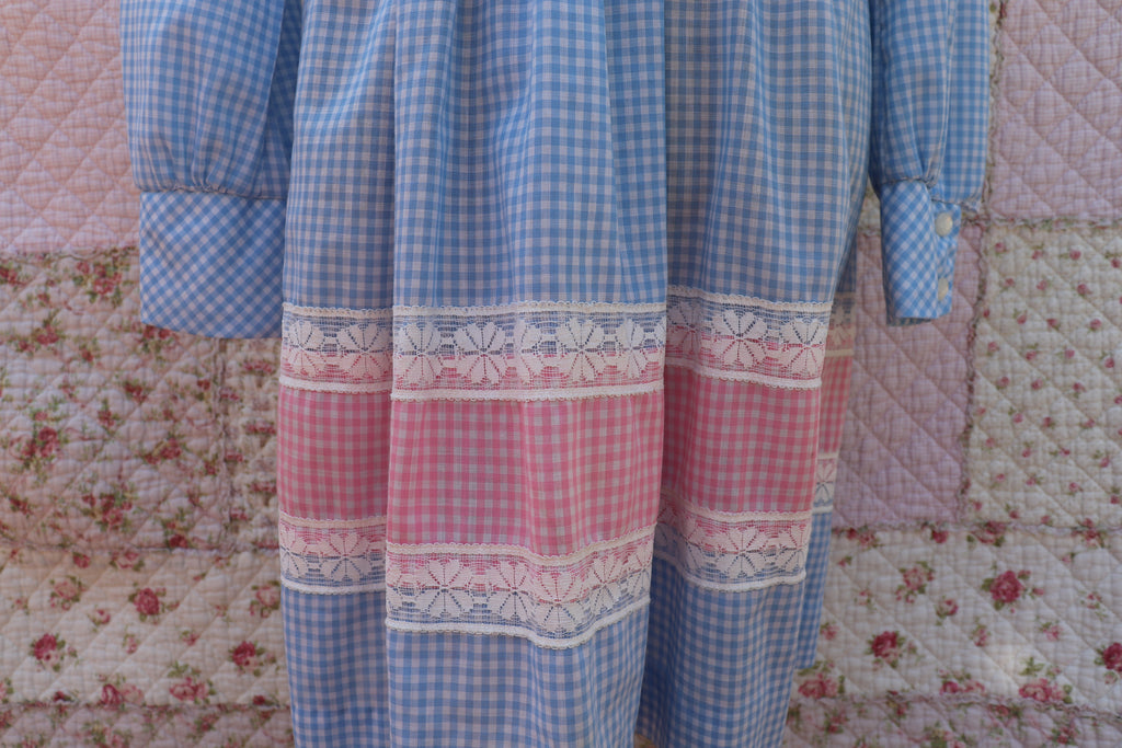 Soak up the sun in the iris dress from J&J Classics! This 1960s dress features a playful blue and white gingham print, accented with pink and white gingham. The long sleeves and collar add a touch of sophistication, while delicate floral lace details add a hint of sweet charm. Get ready to turn heads and spread some flower power with this dress!