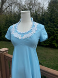 Be bold and turn heads in the jenna dress! This vintage empire waist gown features a bright blue color with playful white appliqué details. Homemade with a gorgeous 1970s silhouette, it is perfect for standing out at any summer event!