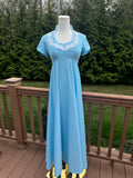 Be bold and turn heads in the jenna dress! This vintage empire waist gown features a bright blue color with playful white appliqué details. Homemade with a gorgeous 1970s silhouette, it is perfect for standing out at any summer event!